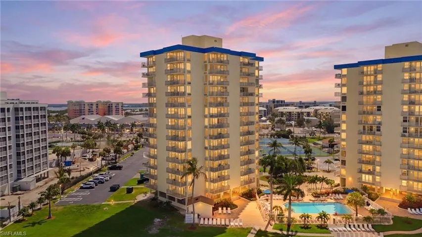 High-rise building with multiple balconies and a blue roof accent - Virtually Edited Image