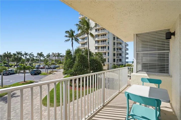 Balcony with white railing and textured exterior wall - Virtually Edited Image