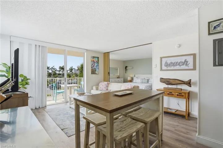 Open concept living area with wood-finish flooring - Virtually Edited Image