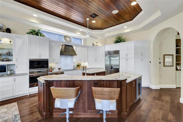 Kitchen features ample cabinet space, a lovely backsplash, a custom designed hood, a large pantry and so much more!