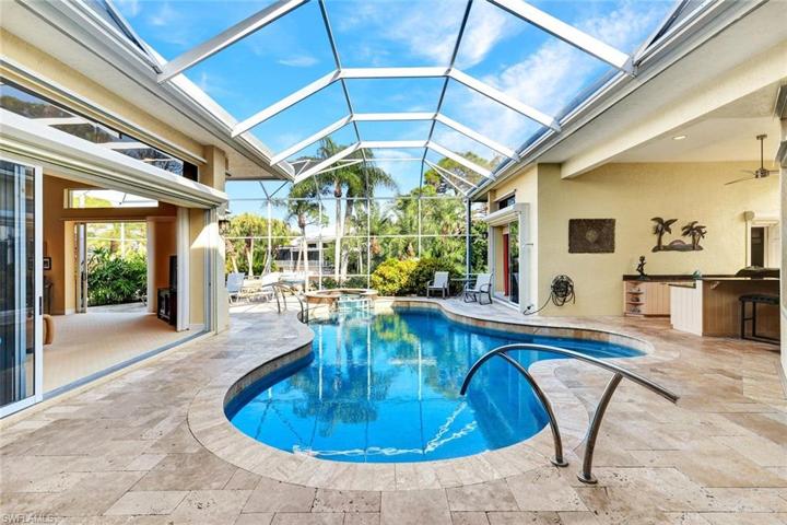 Large screened-in lanai and pool overlook a peaceful preserve view.