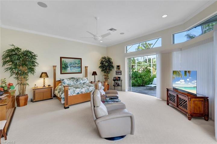 Behind the home is a lovely preserve area with waterfalls and tropical, lush landscaping.