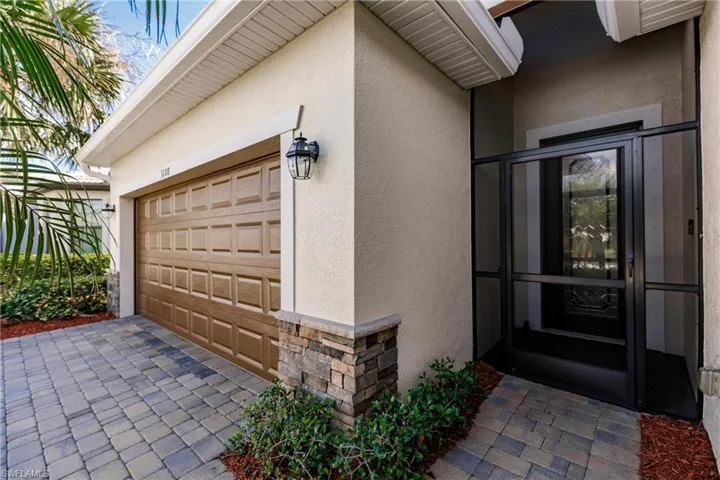 Entry with stone and screened in porch