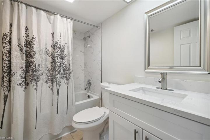 The guest bathroom with a tub/shower combo & gorgeous counters