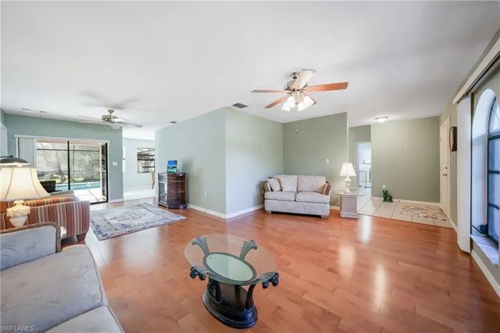 Living room featuring light wood-type flooring and ceiling fan