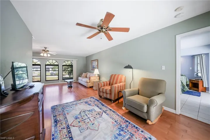 Living room featuring ceiling fan and hardwood / wood-style flooring