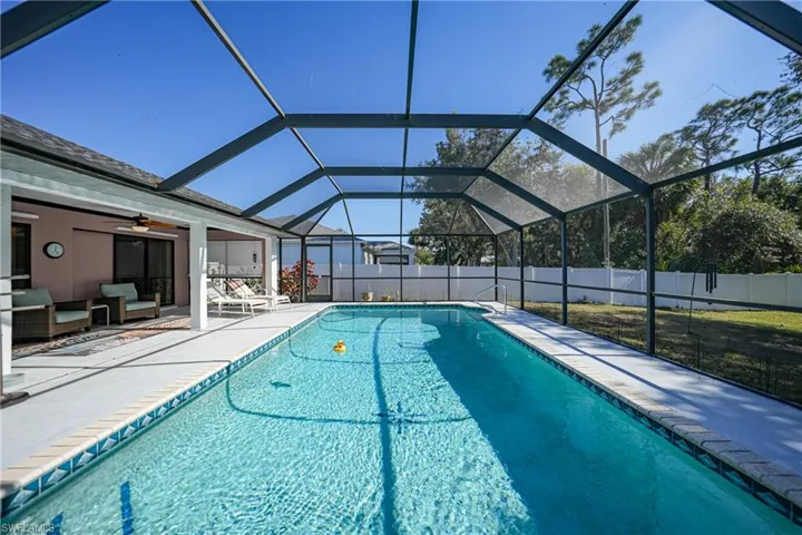 View of swimming pool with an outdoor living space, a lanai, and a patio area