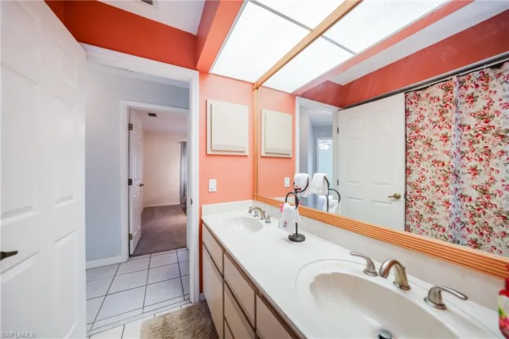 Bathroom featuring tile patterned flooring and vanity