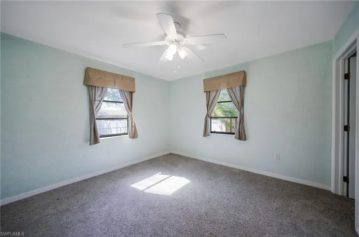 Spare room featuring carpet floors and ceiling fan