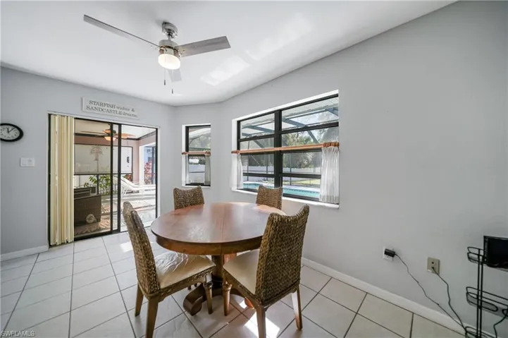 Dining room with ceiling fan and light tile patterned floors