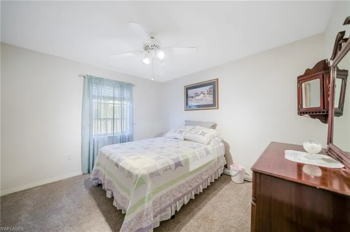 Bedroom featuring light colored carpet and ceiling fan