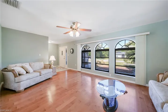 Living room featuring ceiling fan and light wood-type flooring