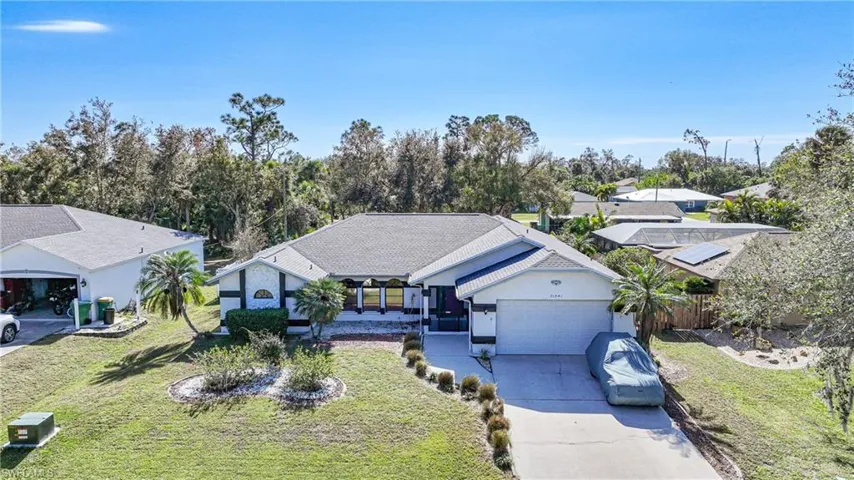 View of front of house featuring a garage and a front yard