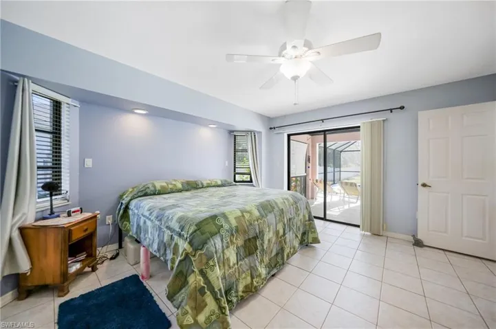 Bedroom featuring access to outside, ceiling fan, and light tile patterned floors