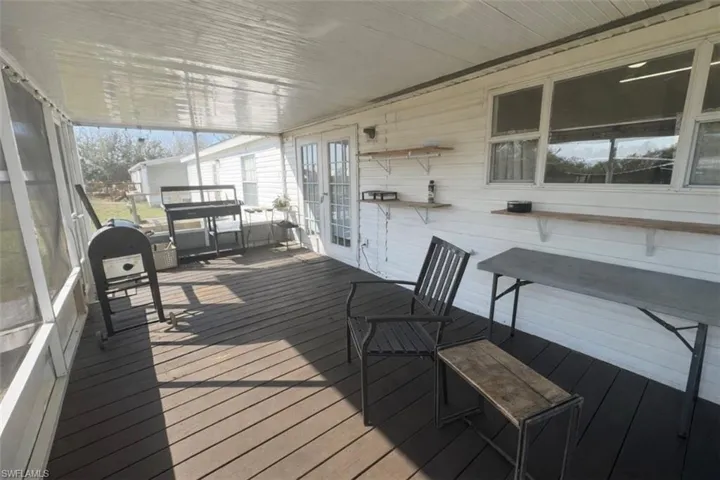 Sunroom with french doors and a wooden deck
