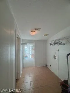 Hall with a textured ceiling