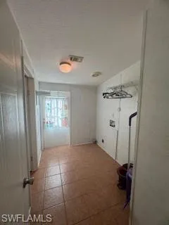 Laundry room with a textured ceiling