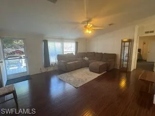 Living area featuring wood finished floors and a ceiling fan