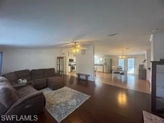 Living room featuring wood finished floors and ceiling fan