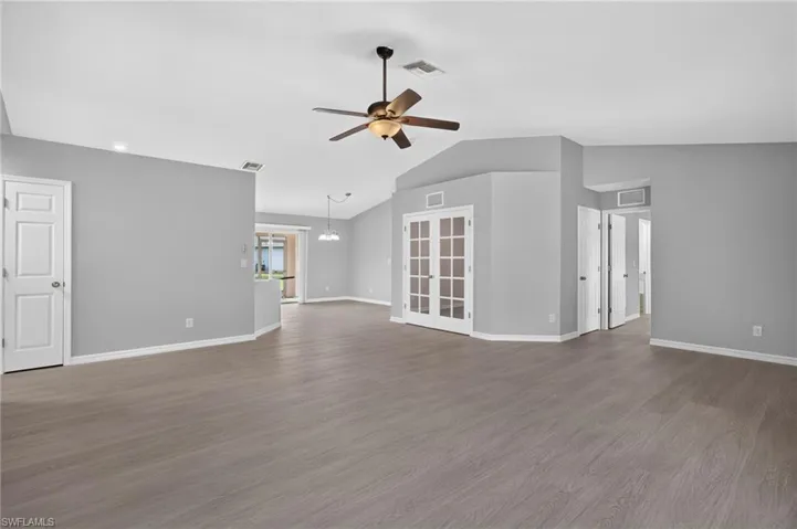 Living room with master bedroom to left, kitchen and dining in middle, and minor bedrooms on the right.