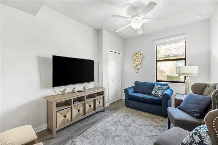 Living room with wood finished floors and a ceiling fan