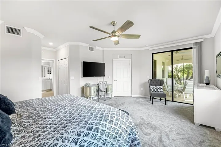 Carpeted bedroom with ornamental molding, access to outside, ceiling fan, and a closet