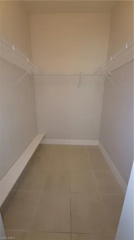 Master walk in closet with tile patterned floors
