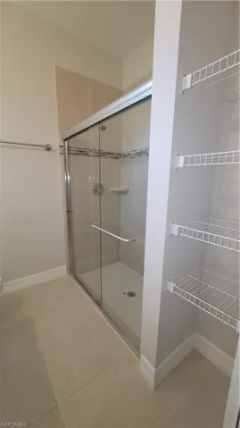Master bathroom with a stall shower and tile patterned flooring