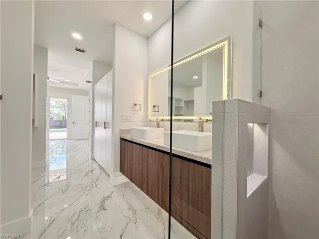 Master -Bathroom with marble tiled floors, double vanity, recessed lighting, a ceiling fan, and baseboards