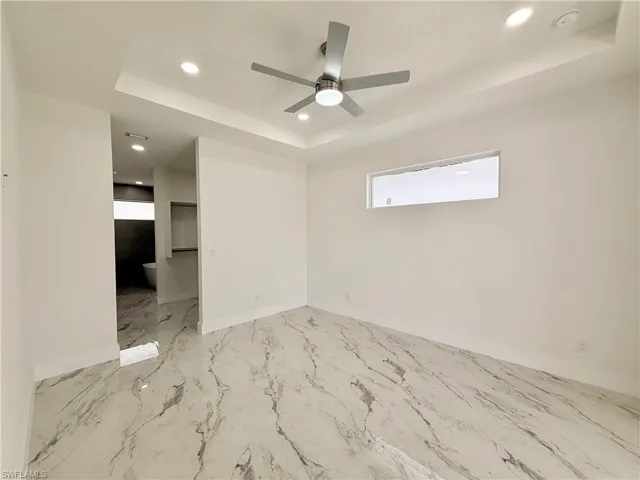 Master room with a raised ceiling, baseboards, recessed lighting, a ceiling fan, and a smoke detector