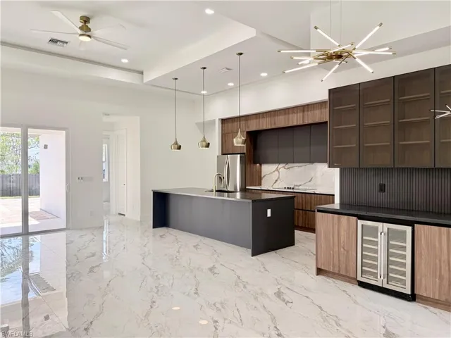 Kitchen featuring wine cooler, modern cabinets, stainless steel refrigerator with ice dispenser, open shelves, and tasteful backsplash