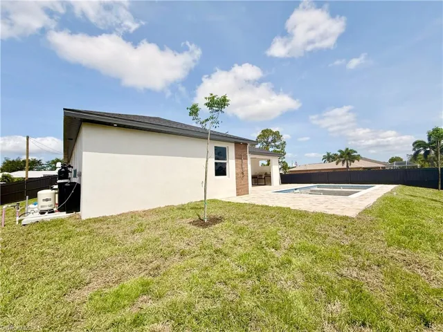Back of house with a patio and stucco siding