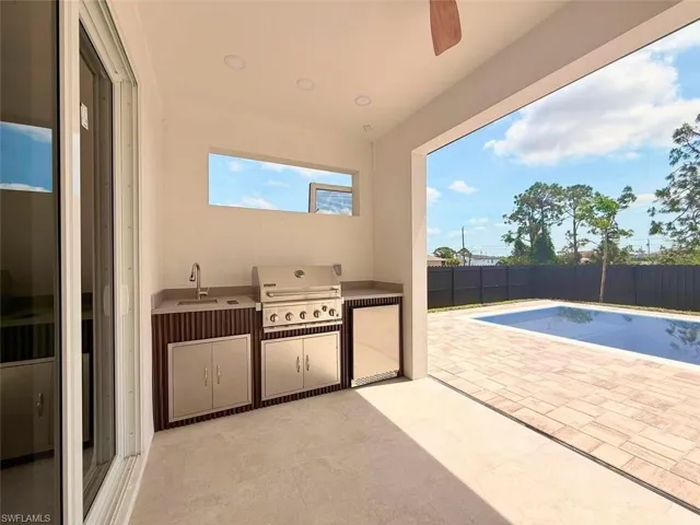 Fenced backyard featuring a sink and a patio area