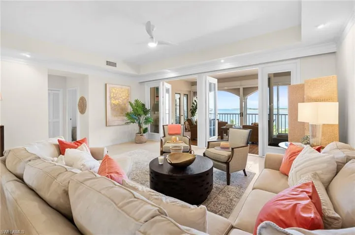 Living room featuring ceiling fan and crown molding