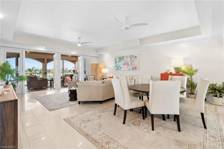 Dining room featuring a raised ceiling and ceiling fan
