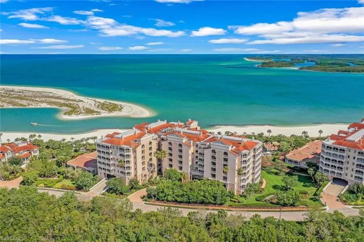 Birds eye view of property featuring a beach view and a water view
