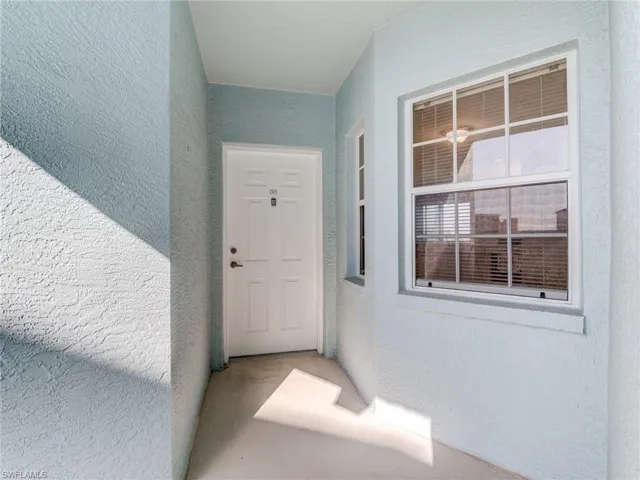 Property entrance featuring stucco siding