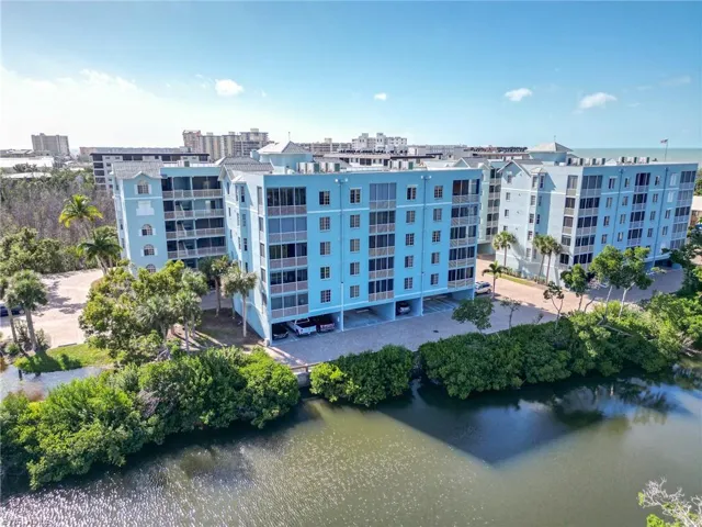 View of apartment building / complex featuring a water view