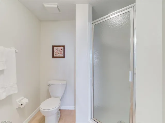 Full bath with a stall shower and toilet