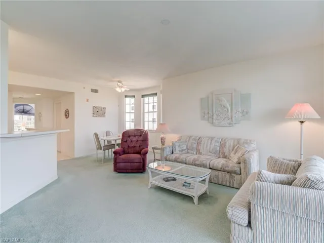 Living room with carpet and ceiling fan