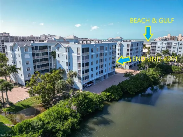 View of apartment building / complex featuring a water view