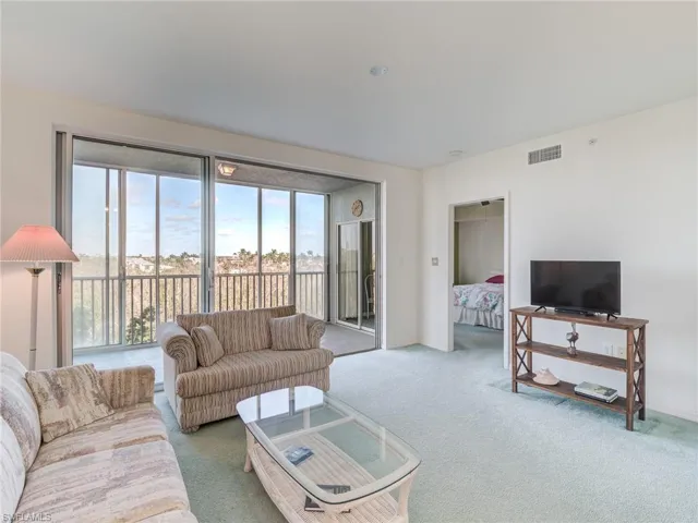 Living area featuring carpet flooring and healthy amount of natural light