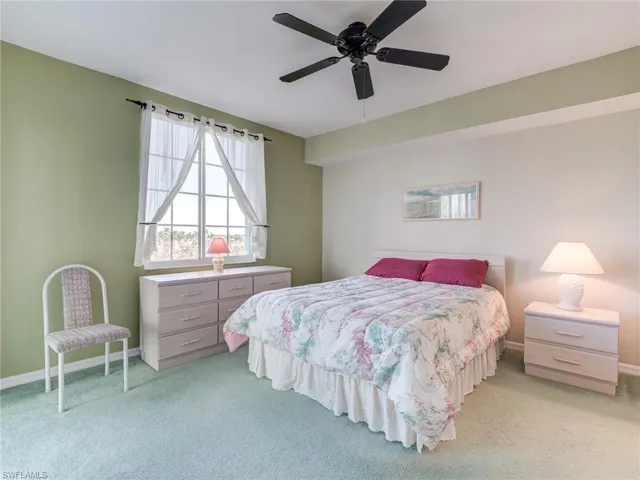 Bedroom featuring light colored carpet and ceiling fan