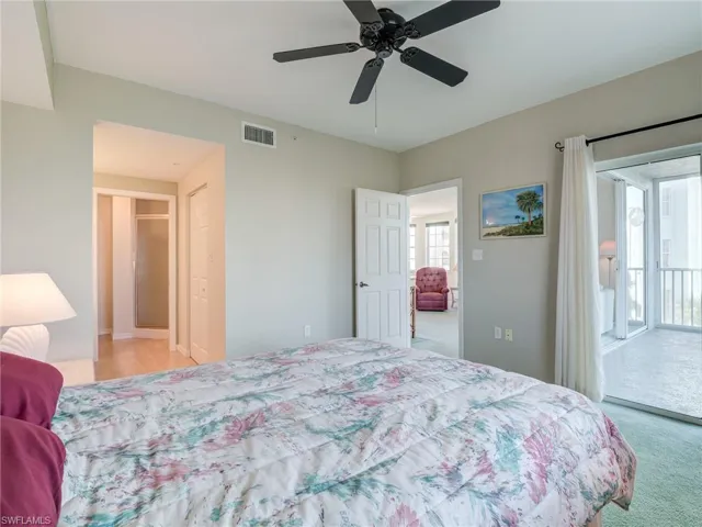 Bedroom with light colored carpet, access to outside, and ceiling fan