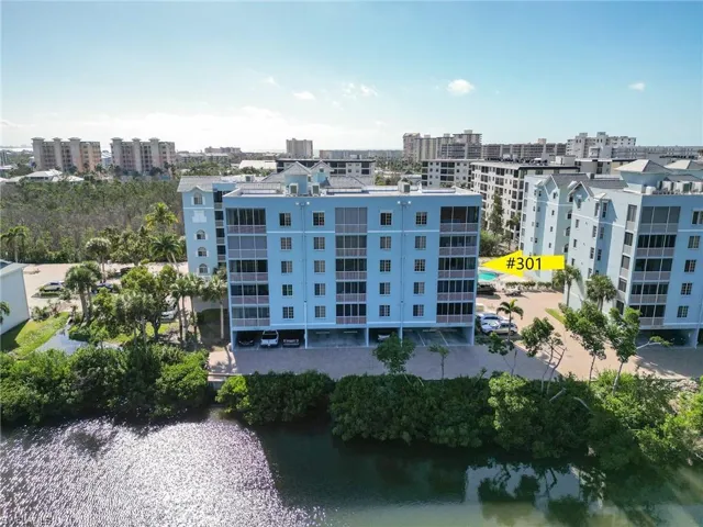 Drone / aerial view of a large body of water and apartment complex / building
