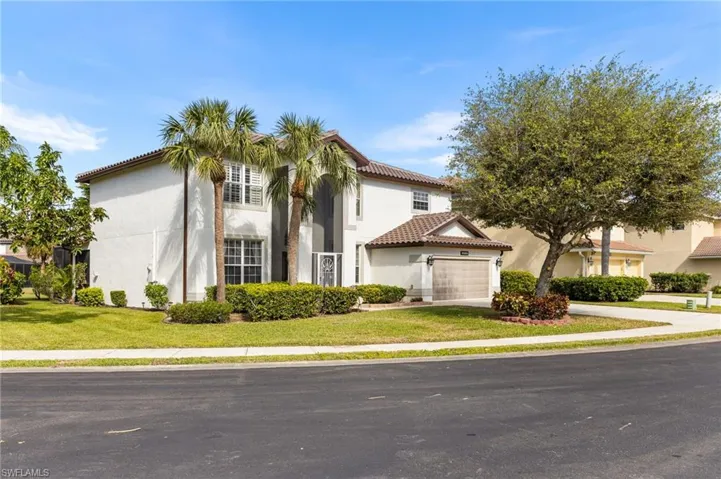 Mediterranean / spanish-style home with a front yard
