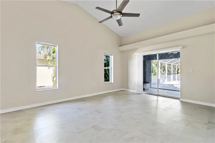 Master bedroom featuring high vaulted ceiling and pool access