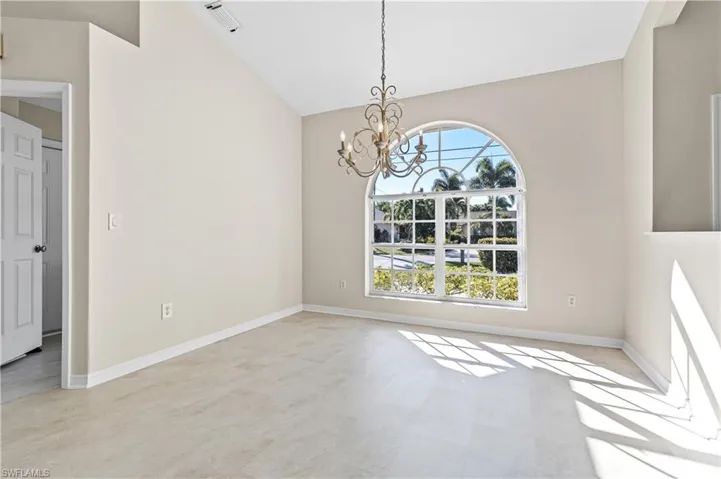 Dining area with vaulted ceiling and a chandelier