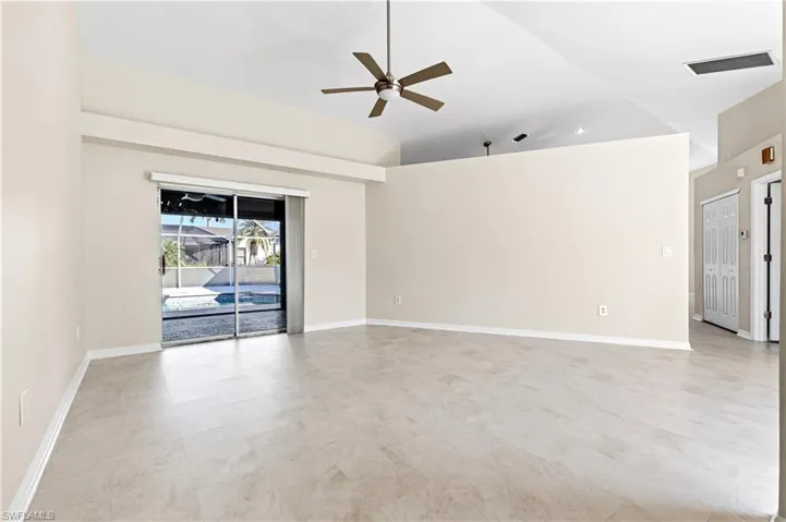 Sitting room featuring a ceiling fan, lofted ceiling and pool access