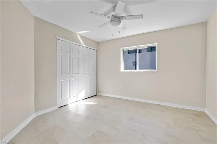 Guest bedroom with ceiling fan and a closet